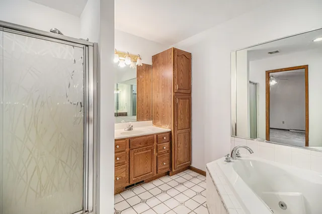 a bathroom with a bathtub sink and mirror