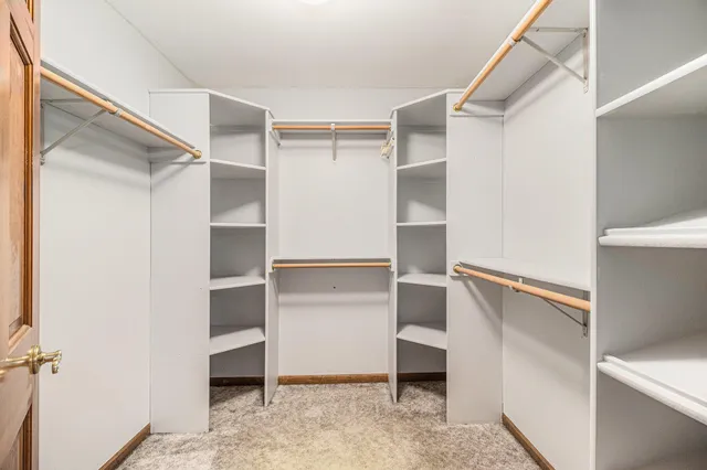 a view of walk in closet with empty racks