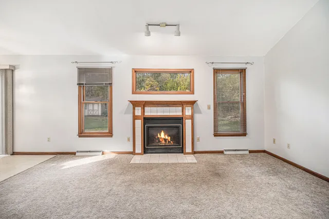 an empty room with furniture and a fireplace