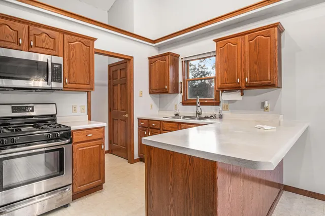 a kitchen with stainless steel appliances granite countertop a sink and a stove top oven with granite countertops