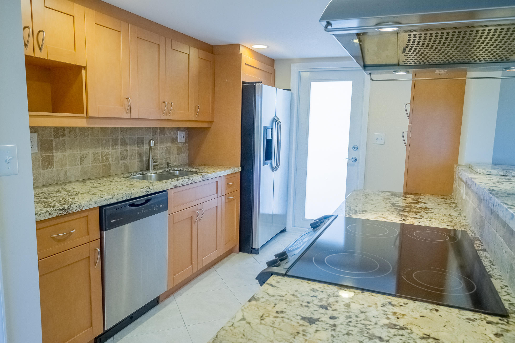 300 East Royal Palm Road, Unit 42B Boca Raton, FL 33432 - Photo 13 of 51 a kitchen with a sink stove and cabinets