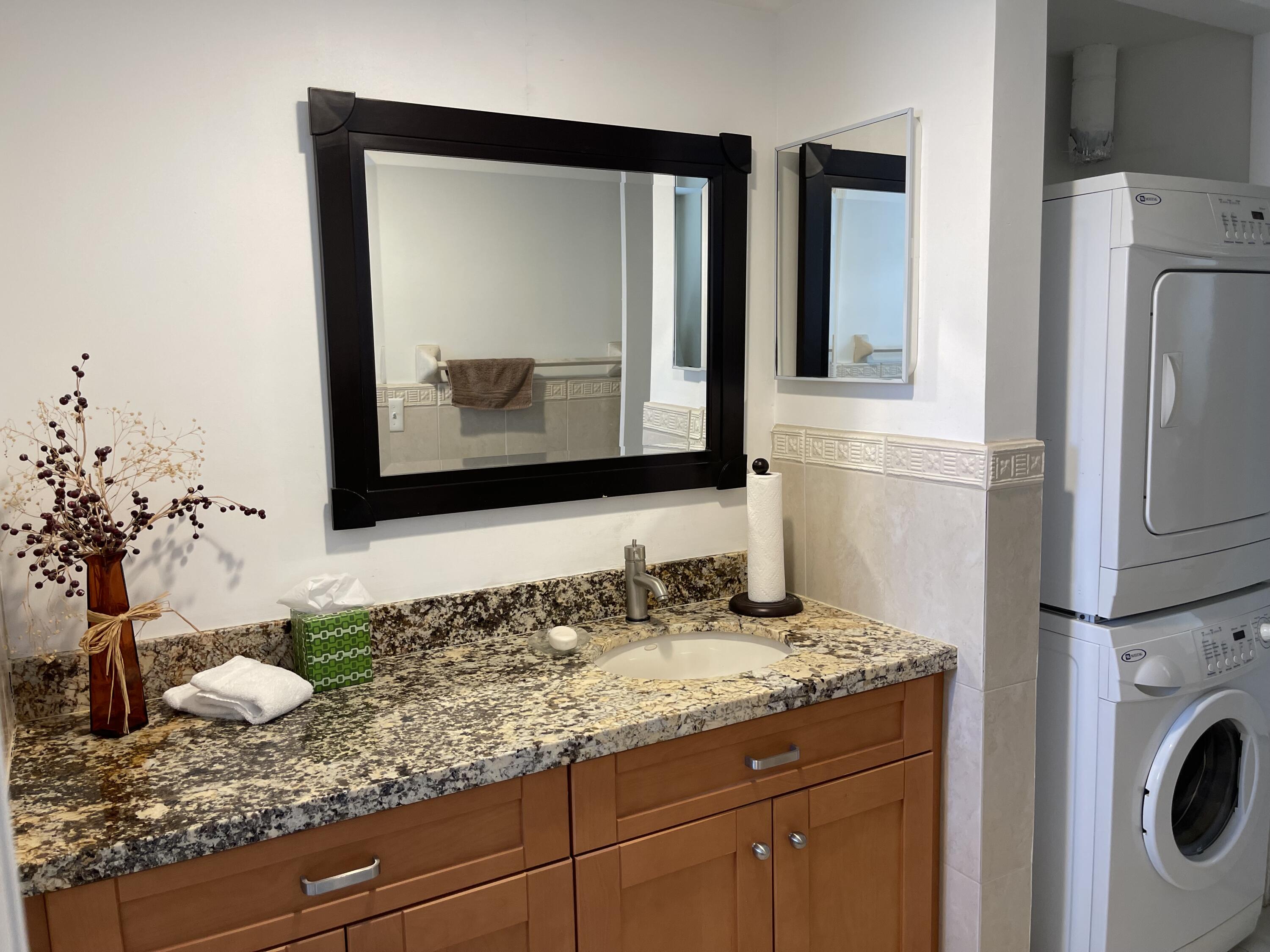 300 East Royal Palm Road, Unit 42B Boca Raton, FL 33432 - Photo 30 of 51 a bathroom with a granite countertop sink and a mirror