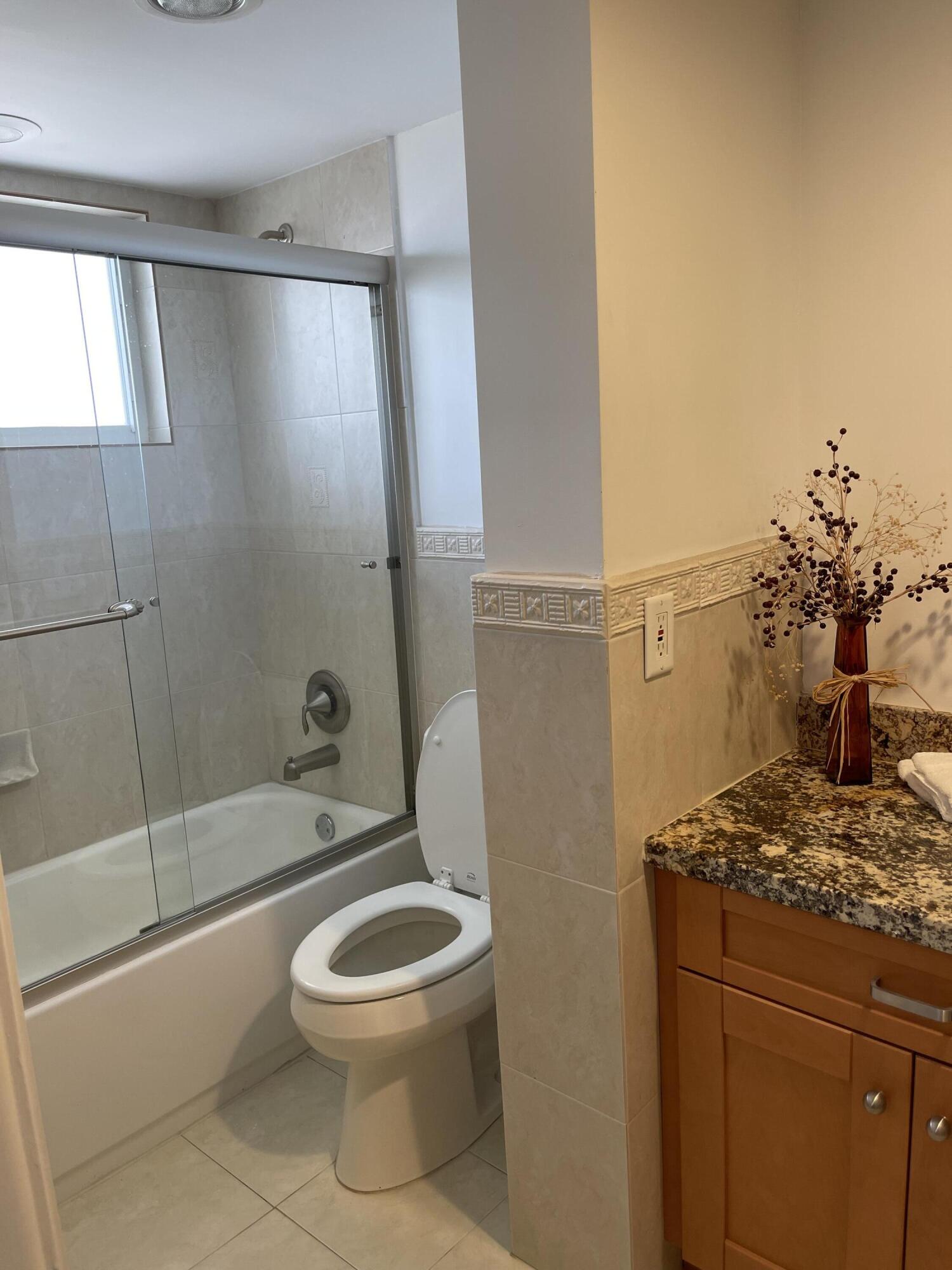 300 East Royal Palm Road, Unit 42B Boca Raton, FL 33432 - Photo 31 of 51 a bathroom with a granite countertop sink a toilet and shower