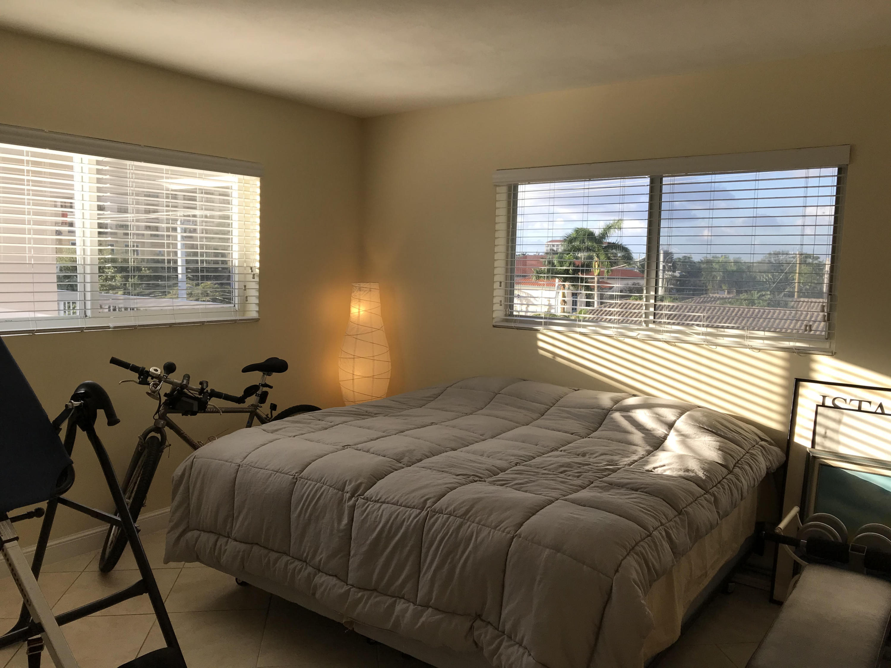 300 East Royal Palm Road, Unit 42B Boca Raton, FL 33432 - Photo 34 of 51 a bed sitting in a bedroom next to a window