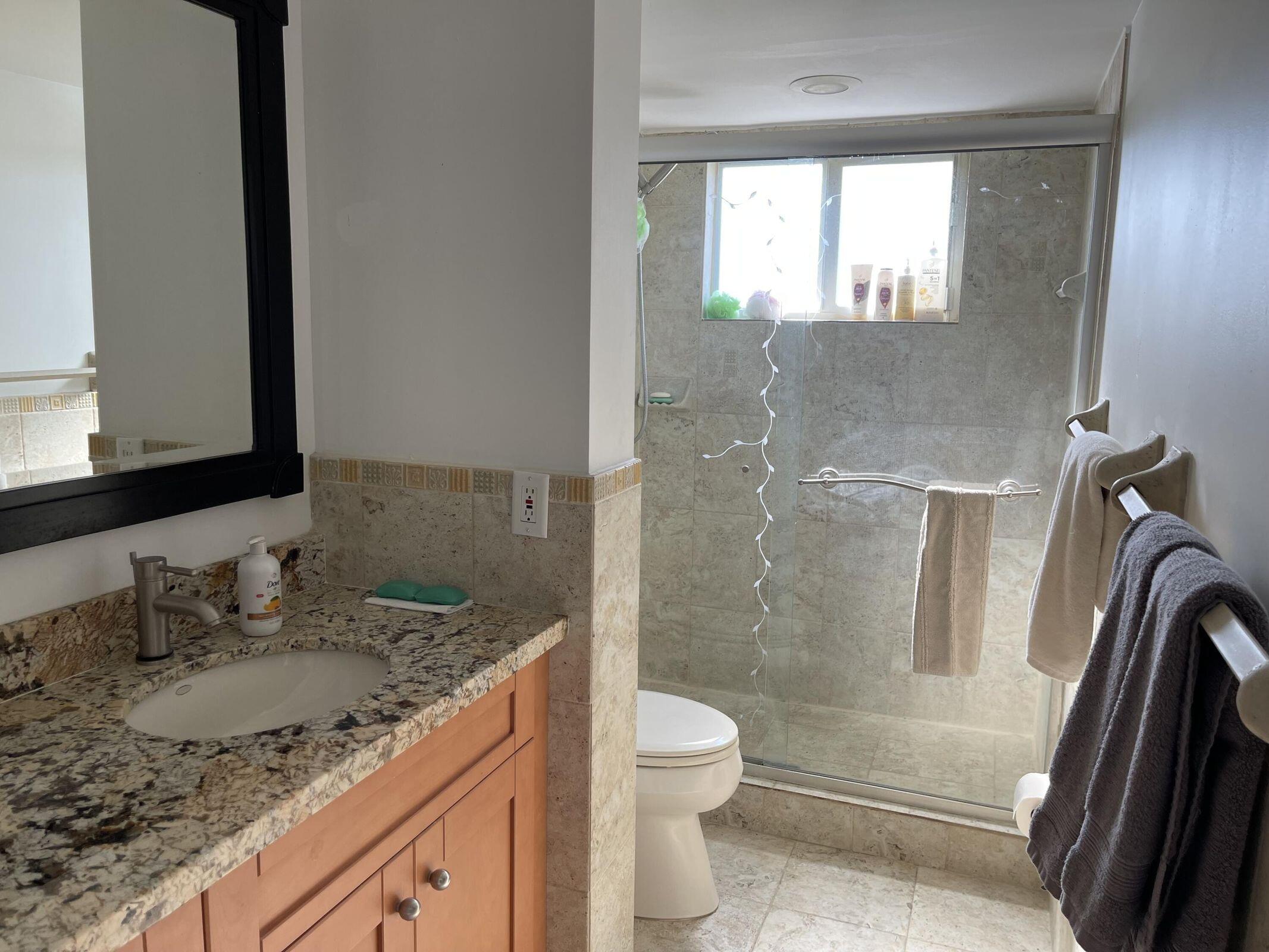 300 East Royal Palm Road, Unit 42B Boca Raton, FL 33432 - Photo 36 of 51 a bathroom with a granite countertop sink toilet and shower