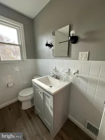 a bathroom with a sink toilet and window