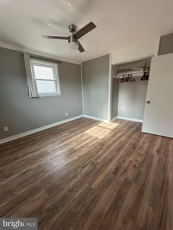 a view of a big room with wooden floor closet and windows