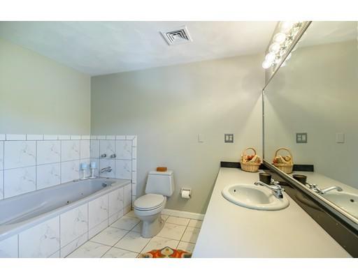 7 Snowberry Road Andover, MA 01810 - Photo 19 of 30 a bathroom with a sink toilet a mirror and vanity