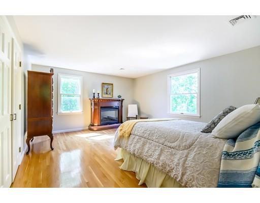7 Snowberry Road Andover, MA 01810 - Photo 22 of 30 a bedroom with a bed and a table in it