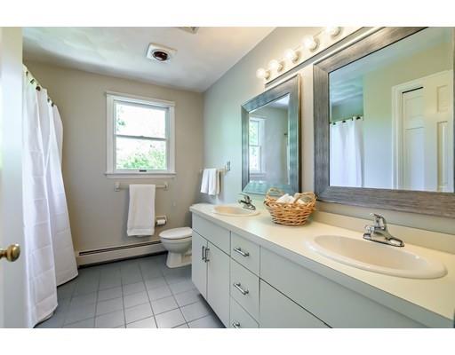7 Snowberry Road Andover, MA 01810 - Photo 24 of 30 a bathroom with a double vanity sink a toilet and a window