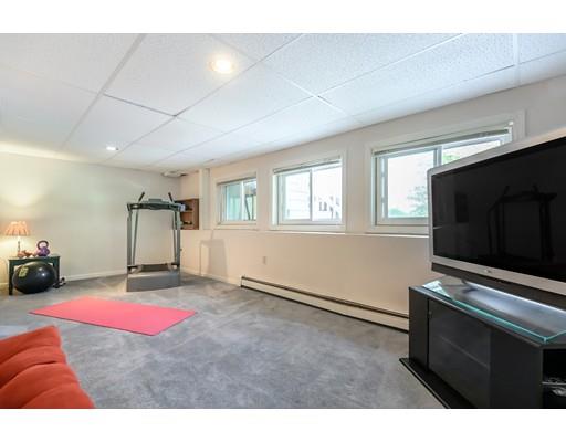 7 Snowberry Road Andover, MA 01810 - Photo 25 of 30 a living room with furniture flat screen tv and floor to ceiling window