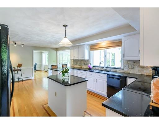 7 Snowberry Road Andover, MA 01810 - Photo 3 of 30 a kitchen with stainless steel appliances granite countertop a sink dishwasher a stove a dining table and chairs with wooden floor