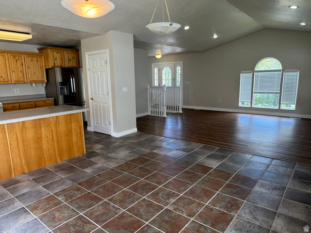 88 Canterbury Lane Logan, UT 84321 - Photo 4 of 37 Expansive living area featuring vaulted ceilings, recessed lighting, and large arch-top windows