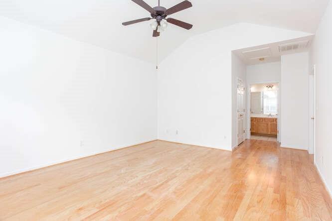 3402 Raes Creek Road, Unit 27 Marietta, GA 30008 - Photo 24 of 32 a view of a room with a wooden floor and a ceiling fan