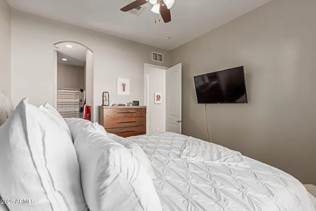 a bedroom with a bed and a flat screen tv