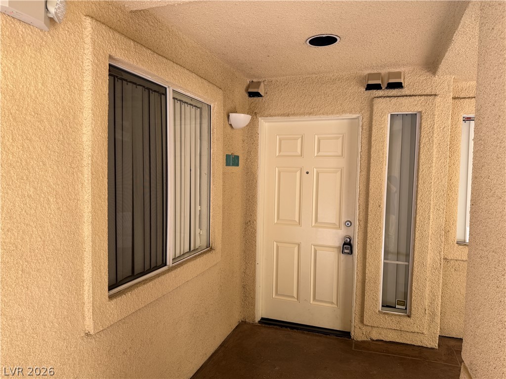 210 East Flamingo Road, Unit 126 Las Vegas, NV 89169 - Photo 2 of 16 Secure entry point with a multi-panel door and adjacent window for natural illumination.