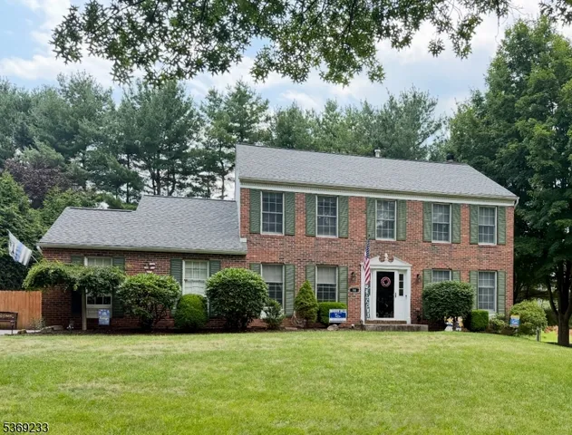 a aerial view of a house with a yard and trees