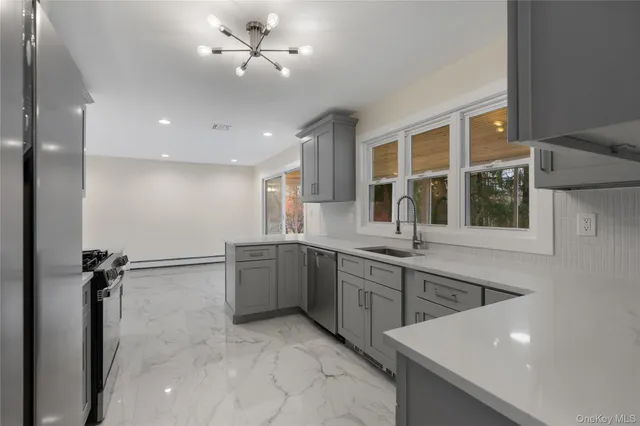 a kitchen with granite countertop a sink stainless steel appliances and cabinets