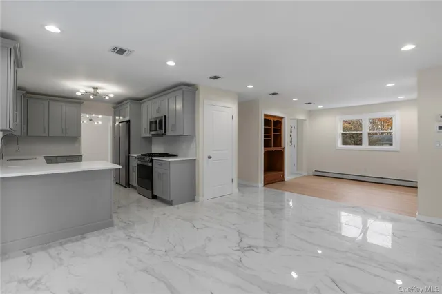 a kitchen with stainless steel appliances a refrigerator and a stove top oven