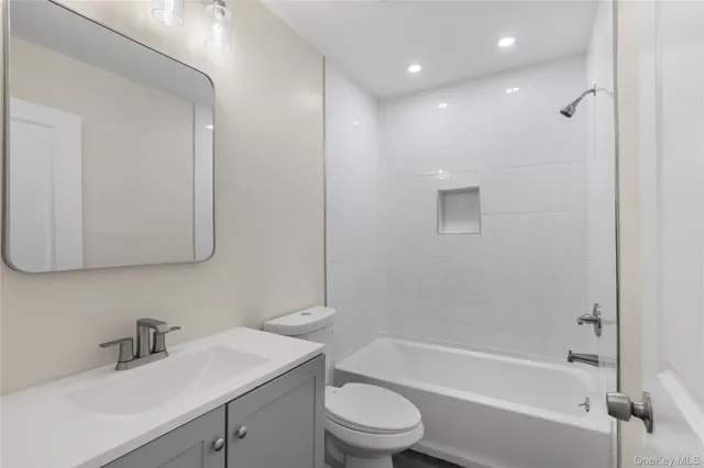 a bathroom with a sink toilet vanity and bathtub