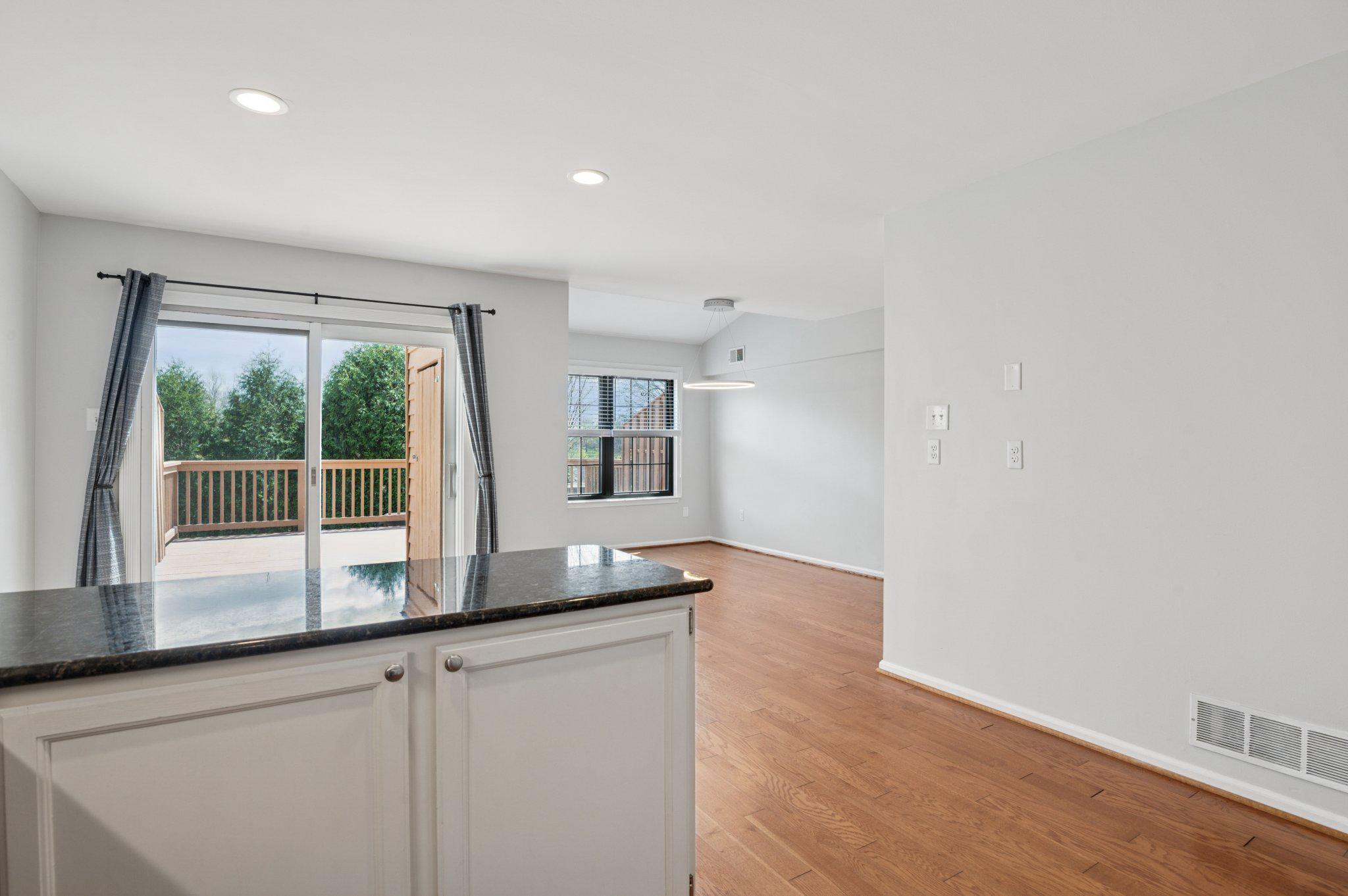 237 McIntosh Road, Unit 82 West Chester, PA 19382 - Photo 6 of 18 a kitchen with kitchen island a sink wooden floor and a large window