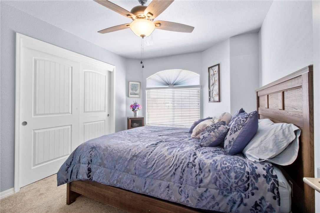 3897 Easy Street Kingman, AZ 86409 - Photo 28 of 53 a spacious bedroom with a bed and a chandelier