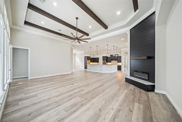 a view of a hallway with wooden floor and a fireplace