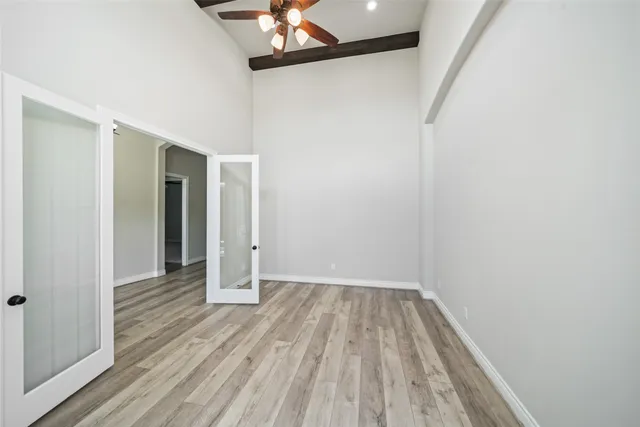a view of a room with wooden floor and a window