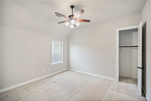 a view of a livingroom with a ceiling fan and window
