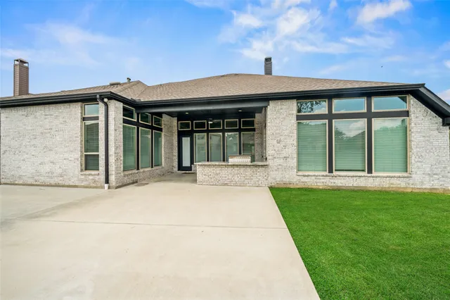 a front view of a house with a garden and yard