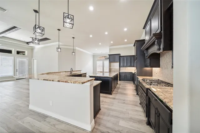 a kitchen with stainless steel appliances granite countertop a stove oven and a refrigerator