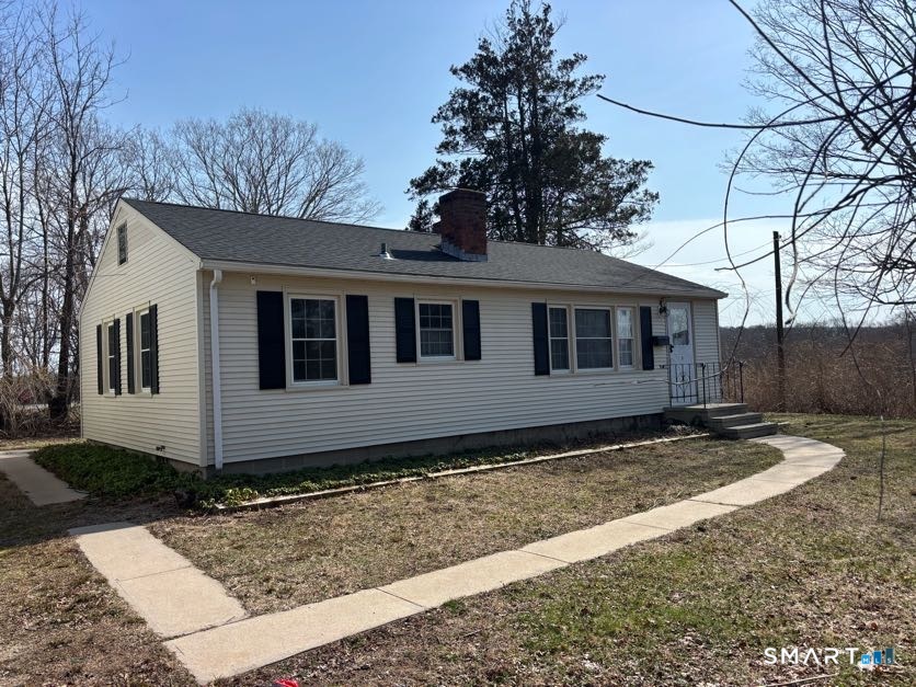 a view of a house with a yard
