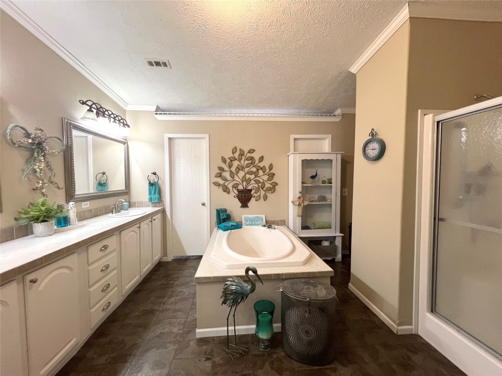 1873 FM 1163 Road El Campo, TX 77437 - Photo 15 of 48 a large bathroom with a granite countertop sink a toilet a mirror and shower