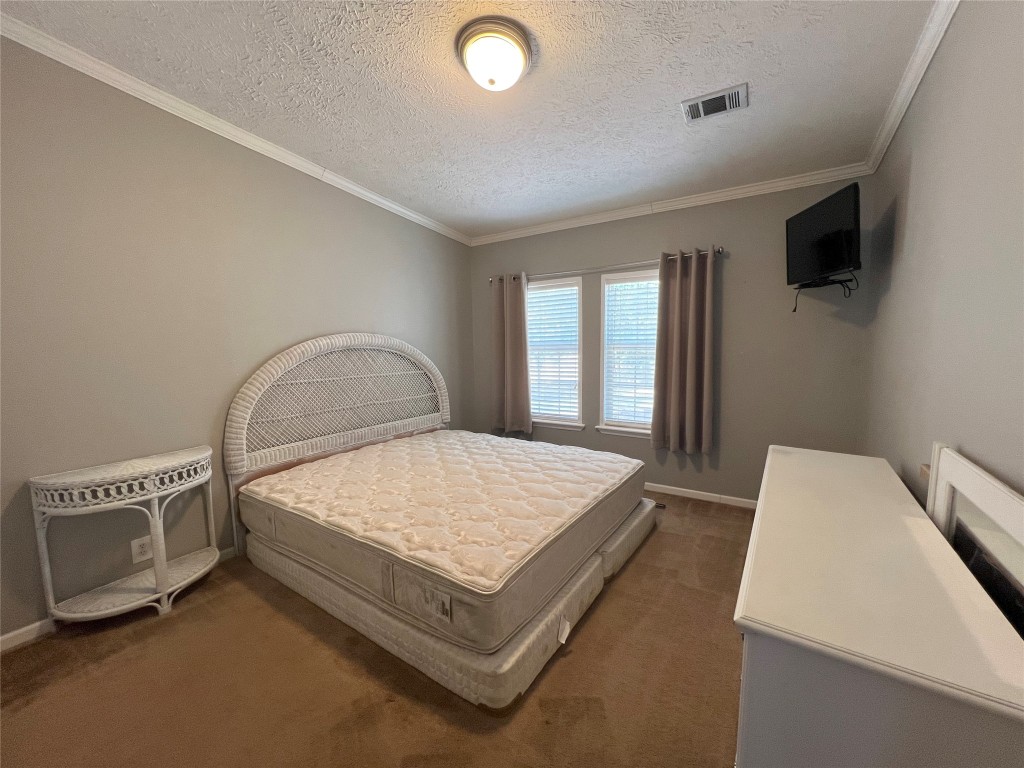 1873 FM 1163 Road El Campo, TX 77437 - Photo 18 of 48 a spacious bedroom with a bed and a flat screen tv