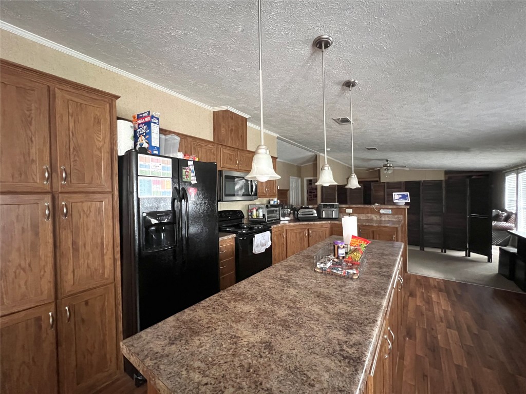 1873 FM 1163 Road El Campo, TX 77437 - Photo 36 of 48 a kitchen with stainless steel appliances granite countertop a refrigerator and a sink