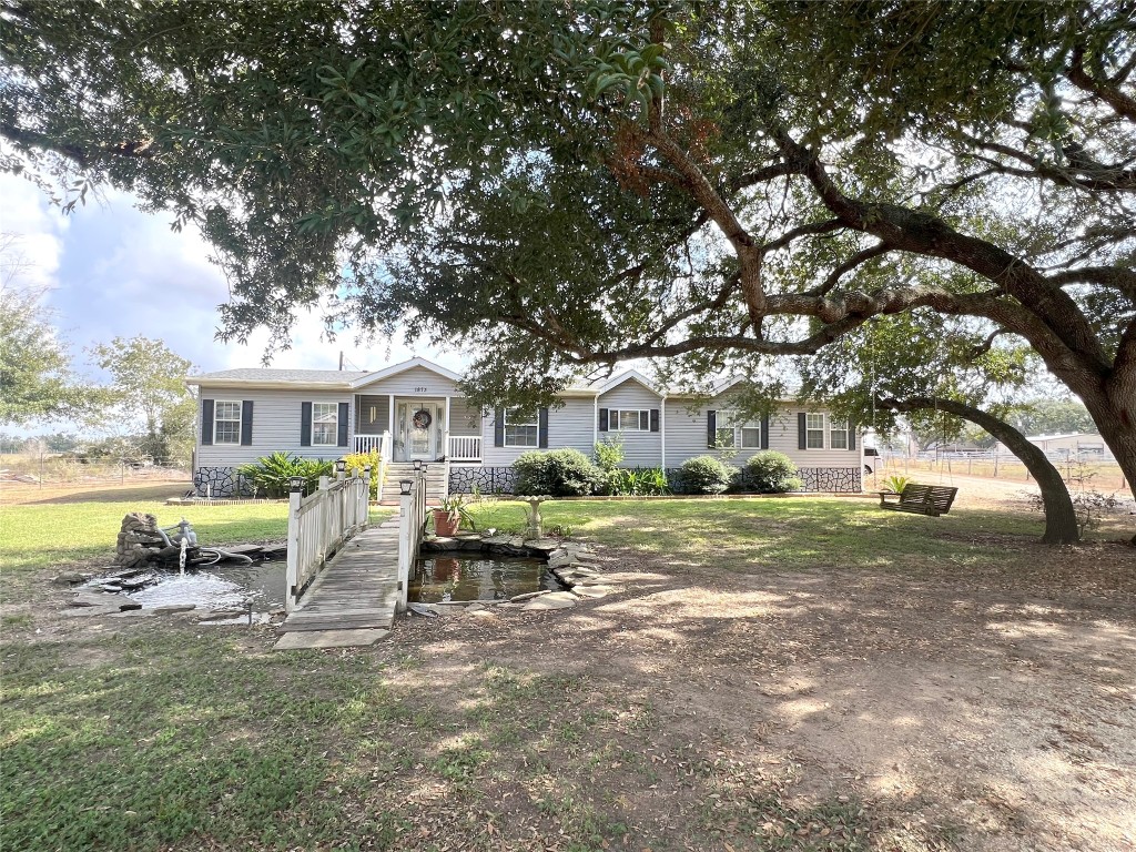 1873 FM 1163 Road El Campo, TX 77437 - Photo 47 of 48 a front view of a house with garden and trees