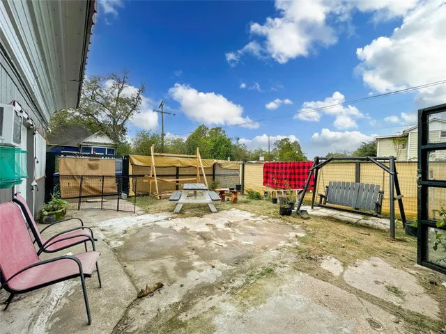 a view of a house with backyard porch and sitting area
