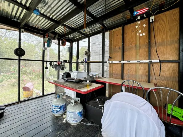 a room with wooden furniture and large windows