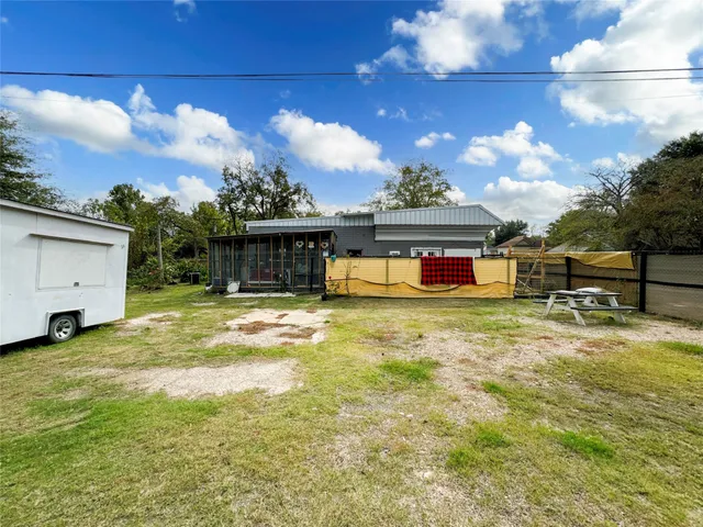 a bed and table sitting in front of a house