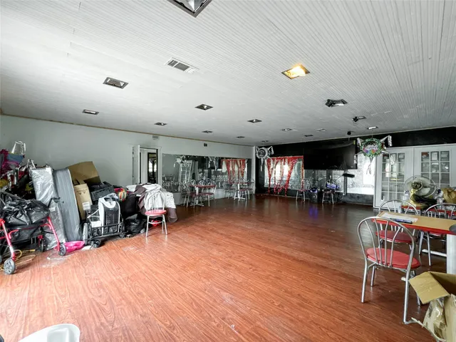 a living room with lots of furniture and a wooden floor