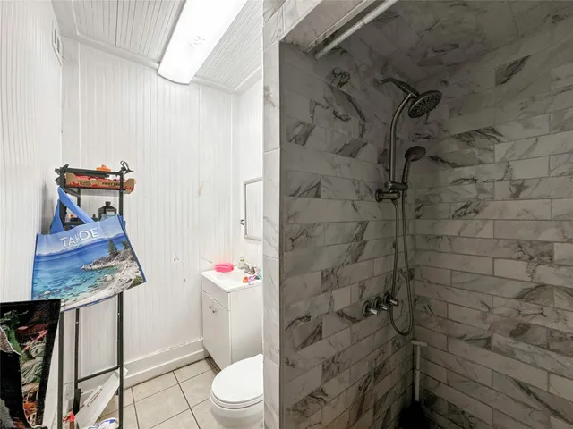 a bathroom with a toilet and a shower