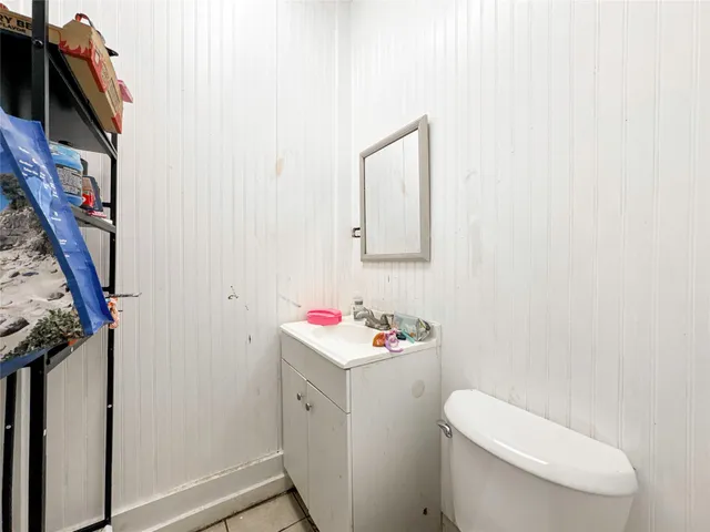 a bathroom with a toilet sink and mirror