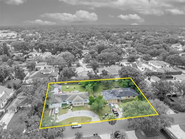 an aerial view of a residential houses with outdoor space