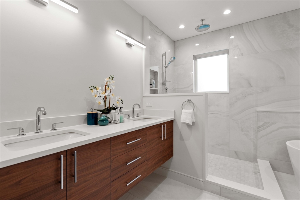 110 Harvard Street, Unit A Newton, MA 02460 - Photo 17 of 30 a bathroom with a sink vanity granite tub and a mirror