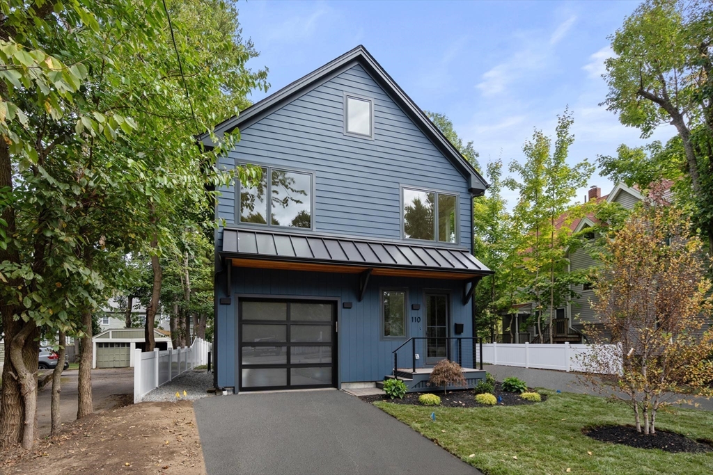 110 Harvard Street, Unit A Newton, MA 02460 - Photo 25 of 30 a front view of a house with a garden and trees