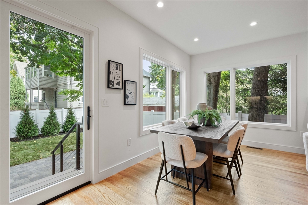 110 Harvard Street, Unit A Newton, MA 02460 - Photo 7 of 30 a dining room with furniture window and wooden floor
