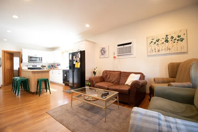 a living room with furniture and kitchen view