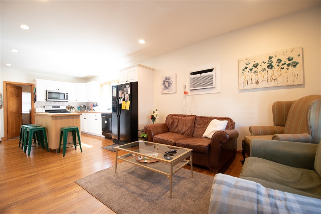 18-20 Greymere Road, Unit 2 Boston, MA 02135 - Photo 2 of 10 a living room with furniture and kitchen view