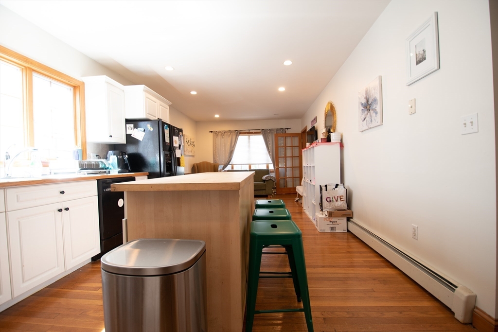 18-20 Greymere Road, Unit 2 Boston, MA 02135 - Photo 3 of 10 a kitchen with stainless steel appliances a refrigerator and a stove top oven
