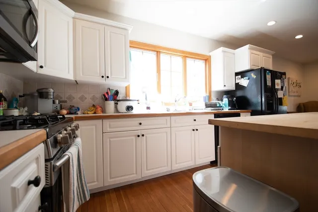 a kitchen with a sink cabinets and window